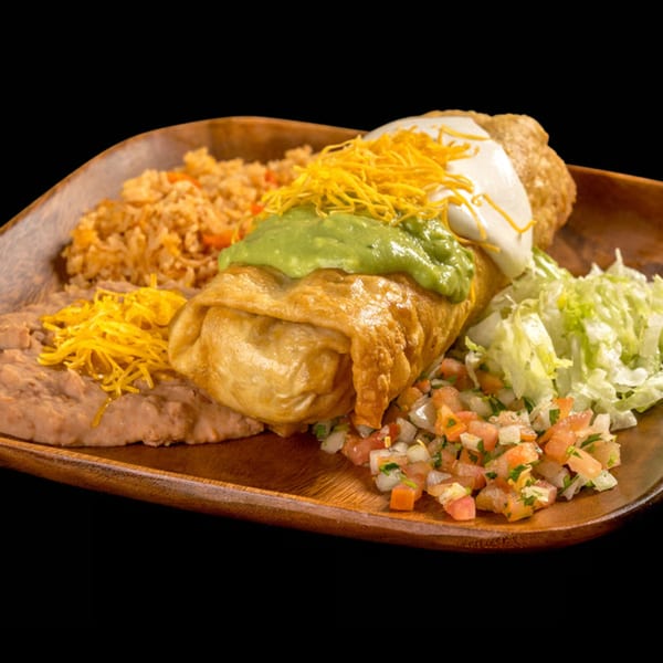 Golden-fried chimichanga topped with guacamole, sour cream, and shredded cheese, served with rice, beans, and pico de gallo.